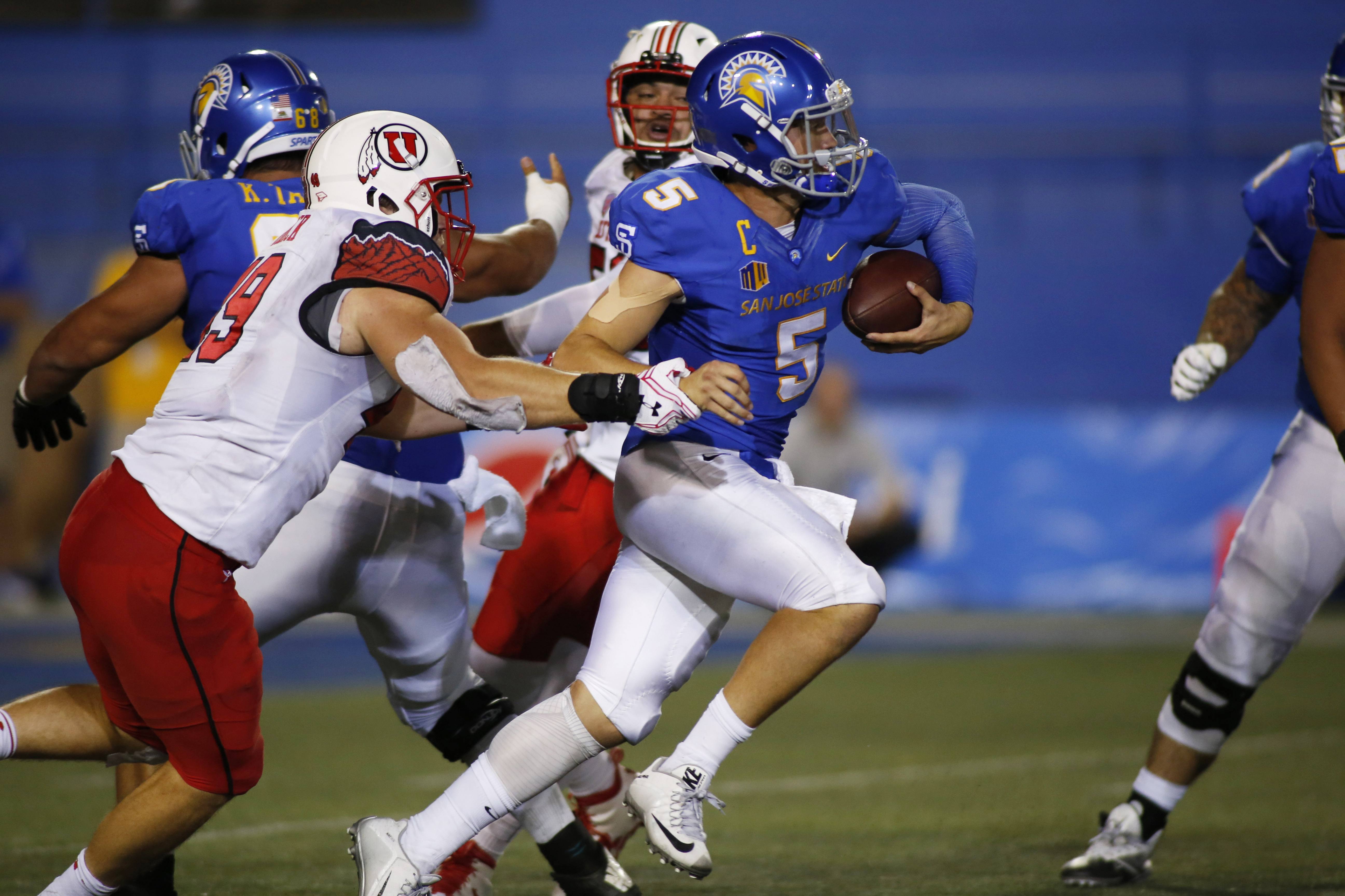 Sep 17, 2016; San Jose, CA, USA; San Jose State Spartans quarterback Kenny Potter (5) runs with the ball as Utah Utes defensive end Hunter Dimick (49) grabs his arm during the game at Spartan Stadium. Mandatory Credit: Stan Szeto-USA TODAY Sports