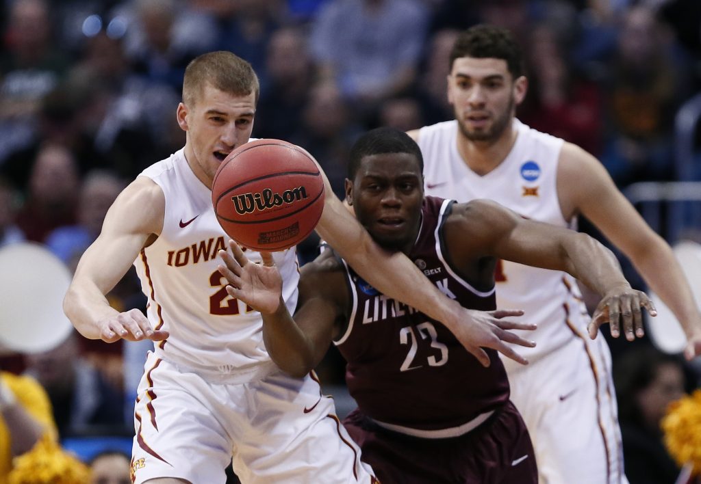 Mar 19, 2016; Denver , CO, USA; Iowa State Cyclones guard Matt Thomas (21) and Arkansas Little Rock Trojans guard Kemy Osse (23) scramble for a loose ball early in first half action of Iowa State vs Arkansas Little Rock during the second round of the 2016 NCAA Tournament at Pepsi Center. Mandatory Credit: Isaiah J. Downing-USA TODAY Sports