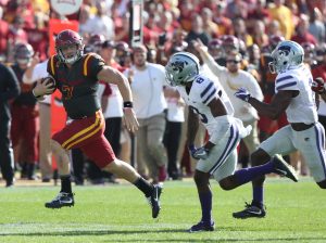 Oct 29, 2016; Ames, IA, USA; Iowa State Cyclones quarterback Joel Lanning (7) runs away from Kansas State Wildcats defensive back Duke Shelley (8) and defensive back DJ Reed (2) for a first down at Jack Trice Stadium. The Wildcats beat the Cyclones 31-26. Mandatory Credit: Reese Strickland-USA TODAY Sports